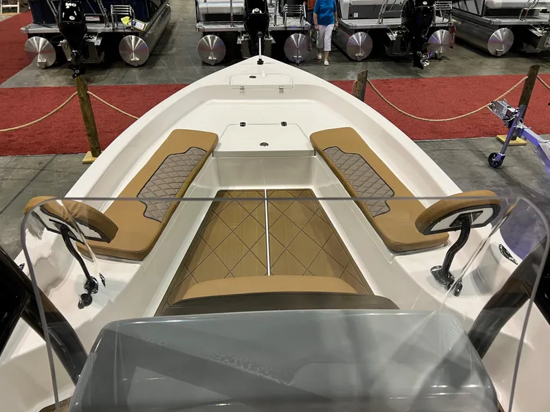 Slide: The Image of 2024 Clearwater 2100 Baystar boat interior with tan seating at a boat show. - 17