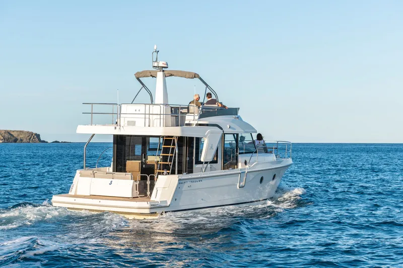 Slide: The Image of 2025 Beneteau Swift Trawler 41 Fly cruising on open sea. - 2