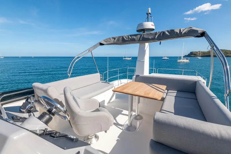 Slide: The Image of 2025 Beneteau Swift Trawler 41 Fly, spacious flybridge with seating, ocean view. - 6