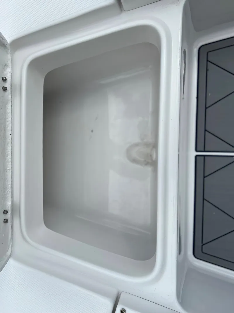 Slide: The Image of 2024 Clearwater 2100 Baystar boat storage compartment and deck detail. - 11