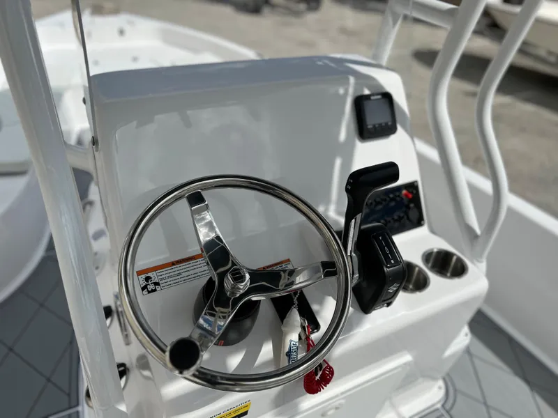 Slide: The Image of 2024 Clearwater 2100 Baystar boat console with steering wheel and controls. - 15