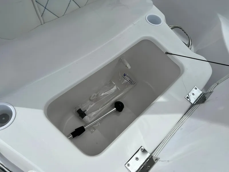 Slide: The Image of 2024 Clearwater 2100 Baystar boat storage compartment with accessories. - 18