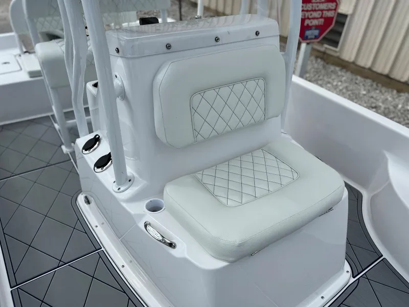 Slide: The Image of 2024 Clearwater 2100 Baystar boat with white cushioned seating and diamond-patterned upholstery. - 20