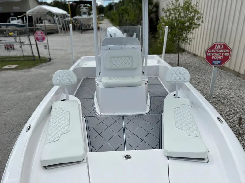 Slide: The Image of 2024 Clearwater 2100 Baystar boat with white cushioned seating and diamond-patterned flooring. - 22
