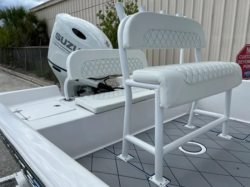 Slide: The Image of 2024 Clearwater 2100 Baystar boat with Suzuki outboard motor and cushioned seating. - 7