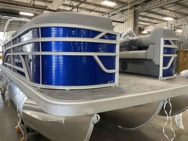 Slide: The Image of 2024 Bennington 20 SVL 3 SPS pontoon boat in a warehouse. - 11