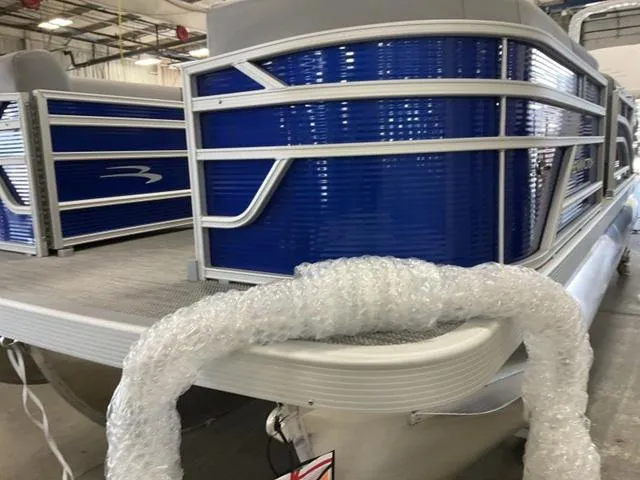 Slide: The Image of 2024 Bennington 20 SVL 3 SPS pontoon boat in a showroom. - 12