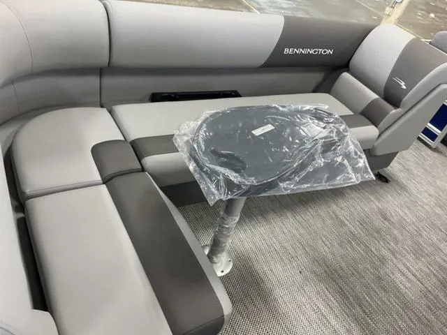 Slide: The Image of 2024 Bennington 20 SVL 3 SPS boat interior with grey seating and table. - 13