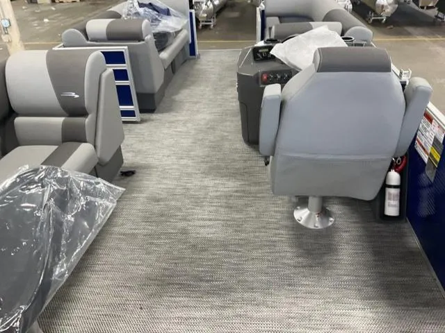 Slide: The Image of 2024 Bennington 20 SVL 3 SPS pontoon boat interior with gray seating and carpet. - 14