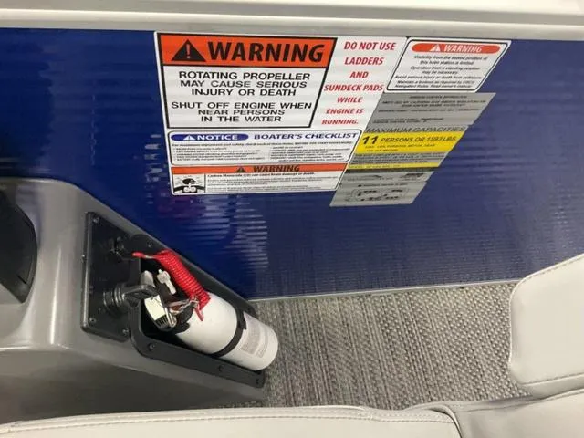 Slide: The Image of Warning labels and fire extinguisher on a 2024 Bennington 20 SVL 3 SPS boat. - 15