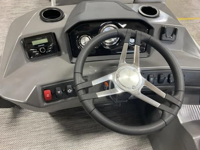 Slide: The Image of 2024 Bennington 20 SVL 3 SPS boat dashboard with steering wheel and control panel. - 16