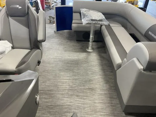 Slide: The Image of 2024 Bennington 20 SVL 3 SPS boat interior with grey seating and table. - 17