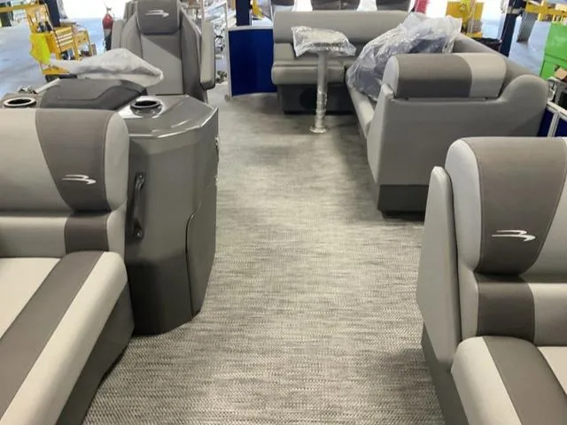 Slide: The Image of 2024 Bennington 20 SVL 3 SPS pontoon boat interior with gray seating and carpet. - 22