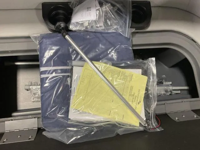 Slide: The Image of 2024 Bennington 20 SVL 3 SPS storage compartment with documents and accessories. - 25