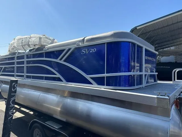 Slide: The Image of 2024 Bennington 20 SVL 3 SPS pontoon boat with blue exterior. - 3