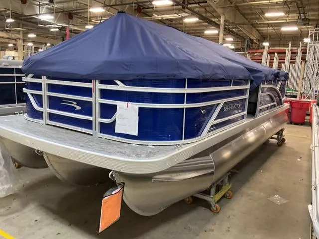 Slide: The Image of 2024 Bennington 20 SVL 3 SPS pontoon boat with blue cover in a warehouse. - 5