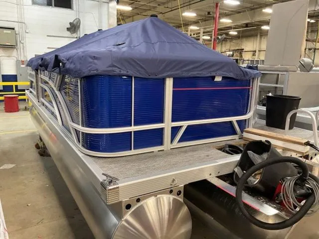 Slide: The Image of 2024 Bennington 20 SVL 3 SPS pontoon boat in a warehouse. - 6