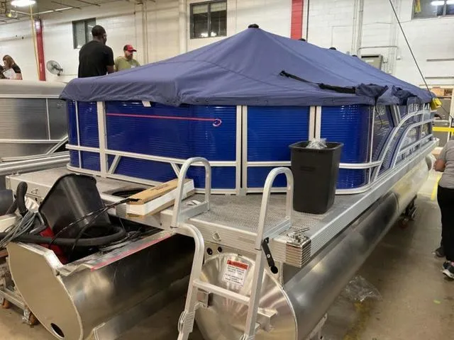 Slide: The Image of 2024 Bennington 20 SVL 3 SPS pontoon boat under assembly in a factory. - 7