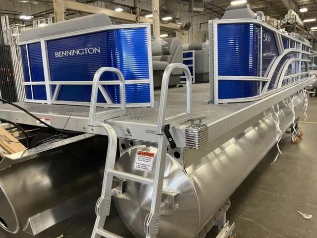 Slide: The Image of 2024 Bennington 20 SVL 3 SPS pontoon boat in a factory setting. - 9