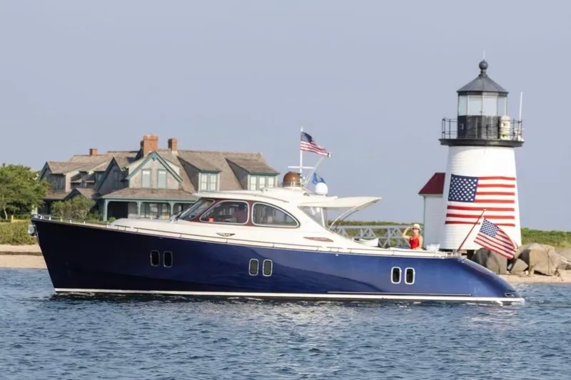 The Image of Zeelander 44 yacht (2012) cruising near a lighthouse and coastal home. - 0