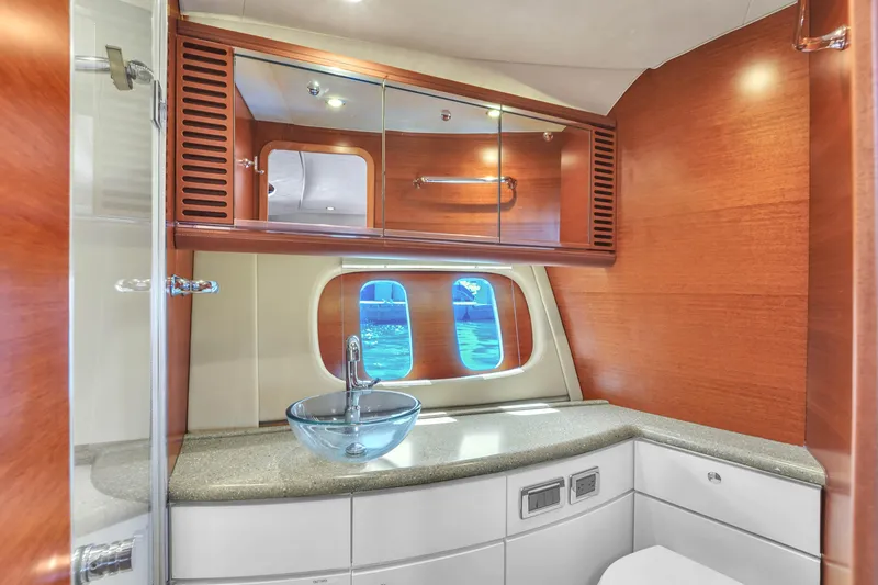 Slide: The Image of Luxurious bathroom interior of 2012 Zeelander 44 yacht with modern glass sink and wooden cabinetry. - 10