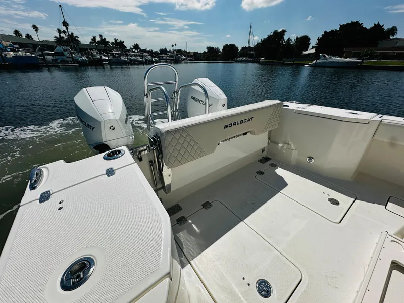 Slide: The Image of 2024 World Cat 260 CC-X boat with twin Mercury engines docked on a sunny day. - 10
