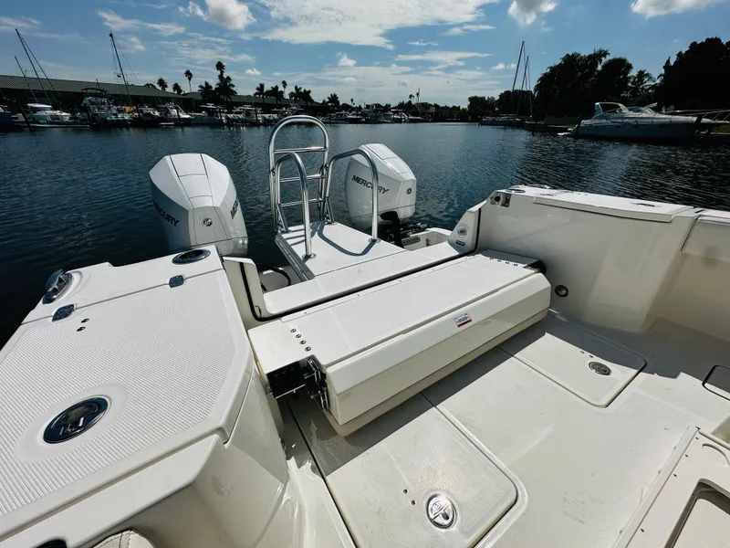 Slide: The Image of 2024 World Cat 260 CC-X boat with dual Mercury engines docked at a marina. - 12