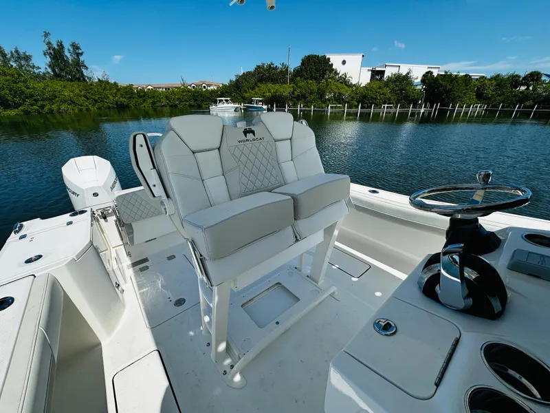 Slide: The Image of 2024 World Cat 260 CC-X boat interior with dual seats and steering wheel. - 14