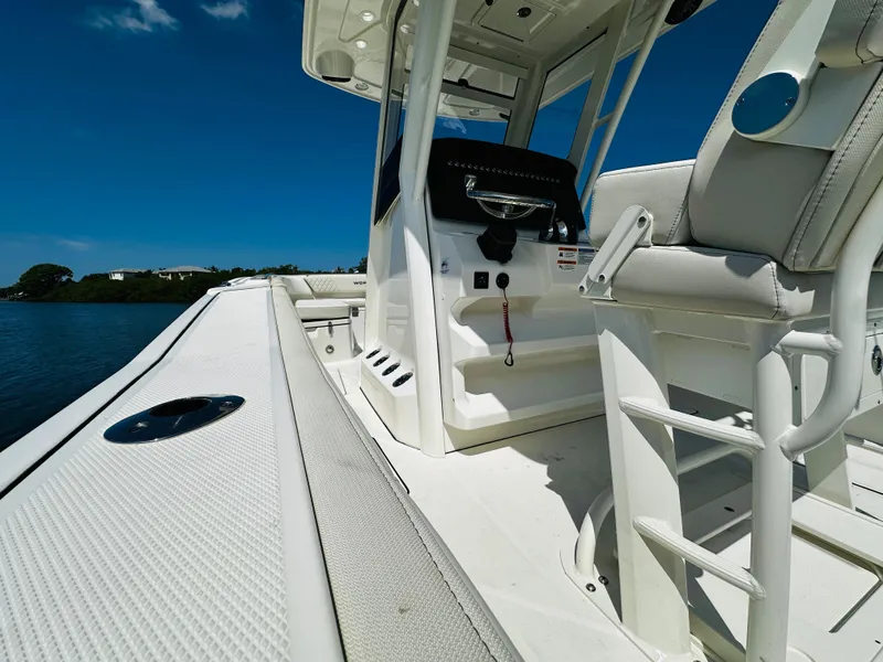 Slide: The Image of 2024 World Cat 260 CC-X boat interior with white seating and console. - 19