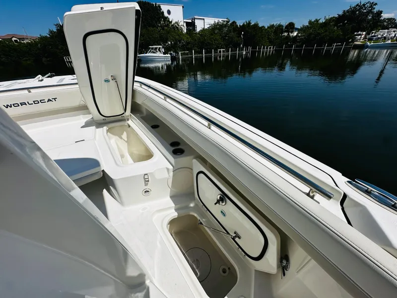 Slide: The Image of 2024 World Cat 260 CC-X boat interior with open storage compartments by the water. - 25