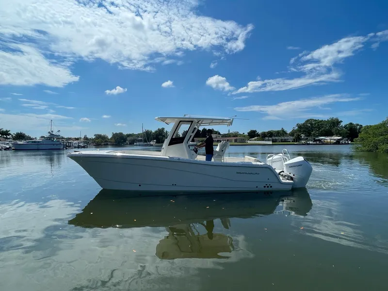Slide: The Image of 2024 World Cat 260 CC-X boat on calm water under a clear blue sky. - 4