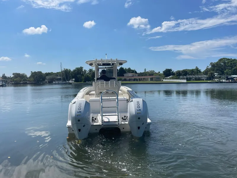 Slide: The Image of 2024 World Cat 260 CC-X boat on calm water with twin engines. - 6
