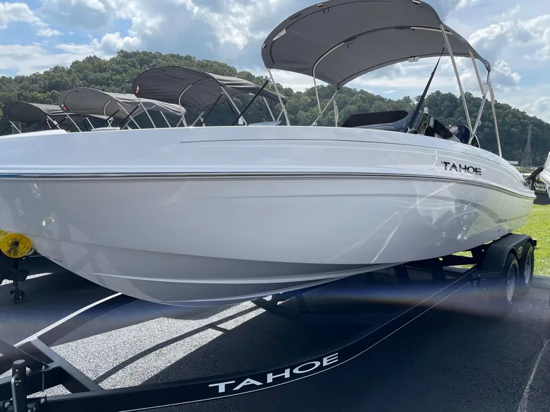 Slide: The Image of 2024 Tahoe T21 boat on trailer under sunny sky. - 1