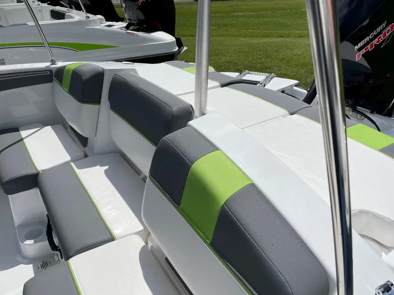 Slide: The Image of 2024 Tahoe T21 boat interior with green and gray seating, sleek design. - 5