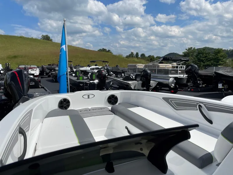 Slide: The Image of 2024 Tahoe T21 boat in a marina, surrounded by other boats under a blue sky. - 6