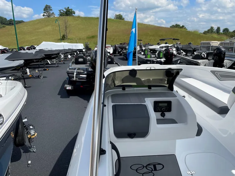 Slide: The Image of 2024 Tahoe T21 boat in a dealership lot, surrounded by other boats. - 8