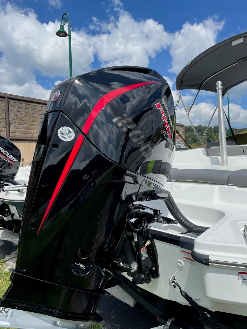 Slide: The Image of 2024 Tahoe T21 boat with powerful outboard motor, sleek design, and vibrant red accents. - 9