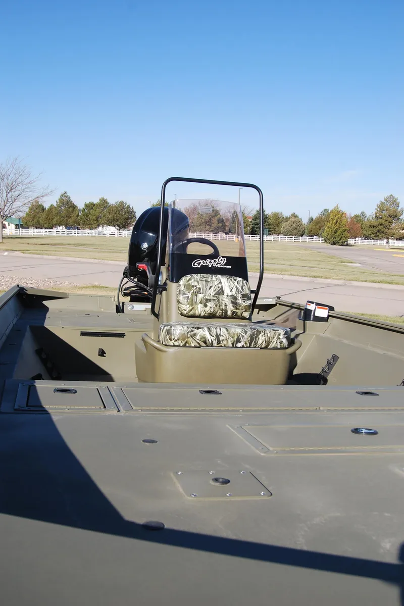 Slide: The Image of 2024 Tracker Grizzly 1860 CC boat with camouflage seating and central console. - 5