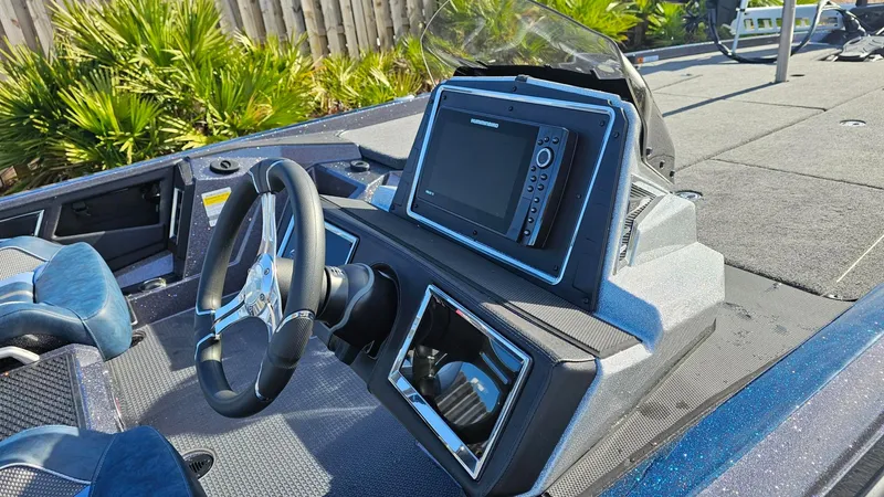 Slide: The Image of 2024 Ranger Z521R boat dashboard with steering wheel and electronic display. - 17