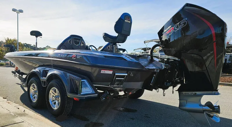 Slide: The Image of 2024 Ranger Z521R bass boat with dual axle trailer and powerful outboard motor. - 4