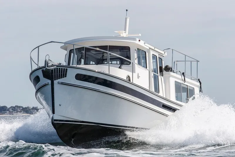 The Image of 2024 Nordic Tug 342 cruising through waves on open water. - 1