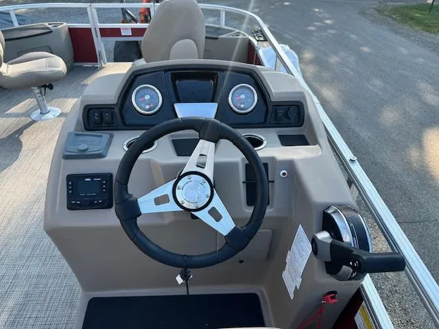 Slide: The Image of 2024 Ranger RP200F boat dashboard with steering wheel and control panel. - 6