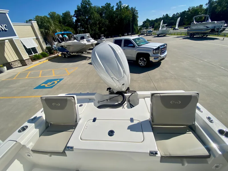 Slide: The Image of 2024 Key West 230 Bay Reef boat with outboard motor in dealership lot. - 7