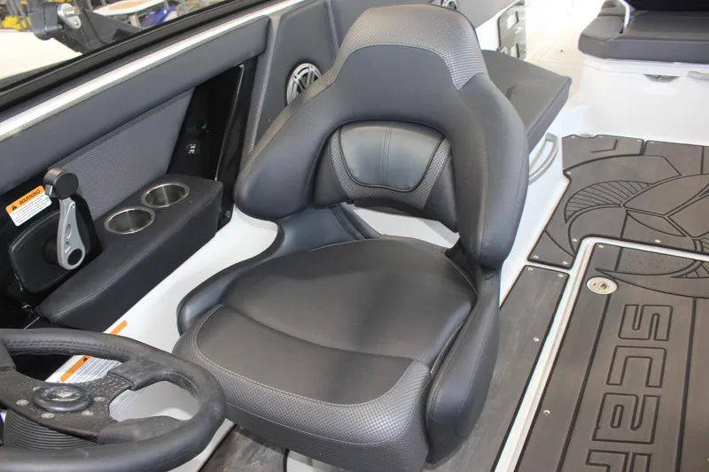 Slide: The Image of 2023 Scarab 285 ID boat interior with black captain's chair and steering wheel. - 10