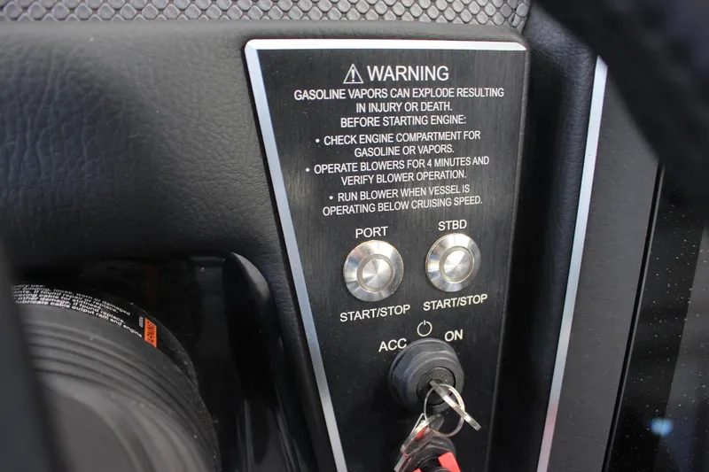 Slide: The Image of 2023 Scarab 285 ID boat ignition panel with safety warning and start/stop buttons. - 13