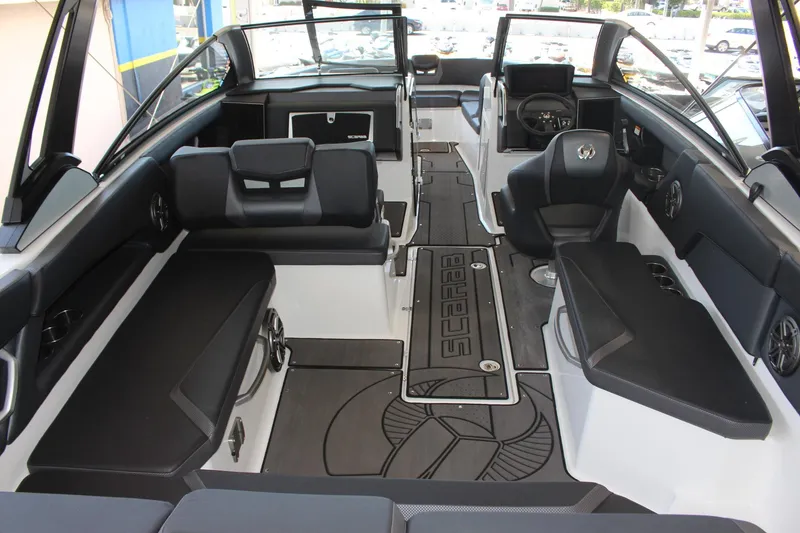 Slide: The Image of 2023 Scarab 285 ID boat interior with black and white seating and modern dashboard. - 5