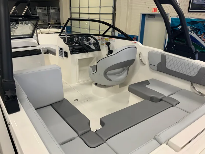 Slide: The Image of 2024 Bayliner VR4 Bowrider OB interior with modern seating and steering console. - 3
