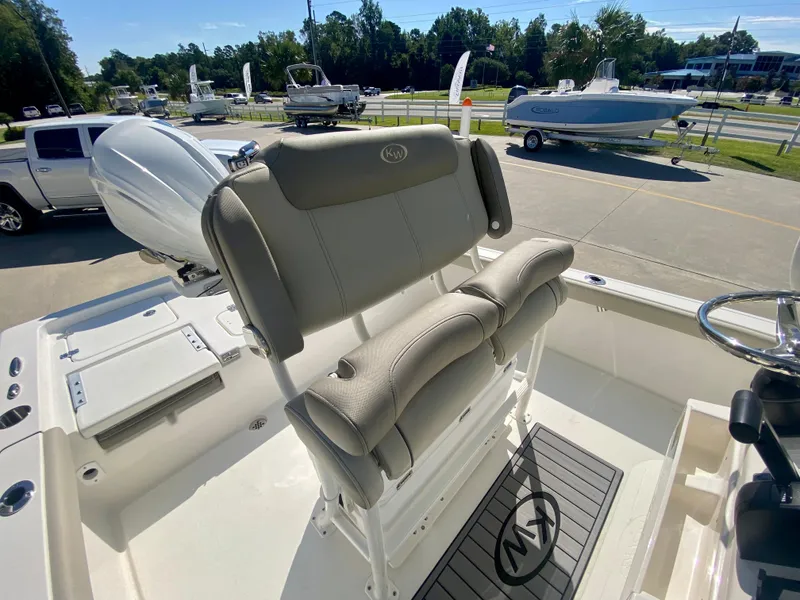 Slide: The Image of 2024 Key West 230 Bay Reef boat with cushioned seating and modern design. - 11