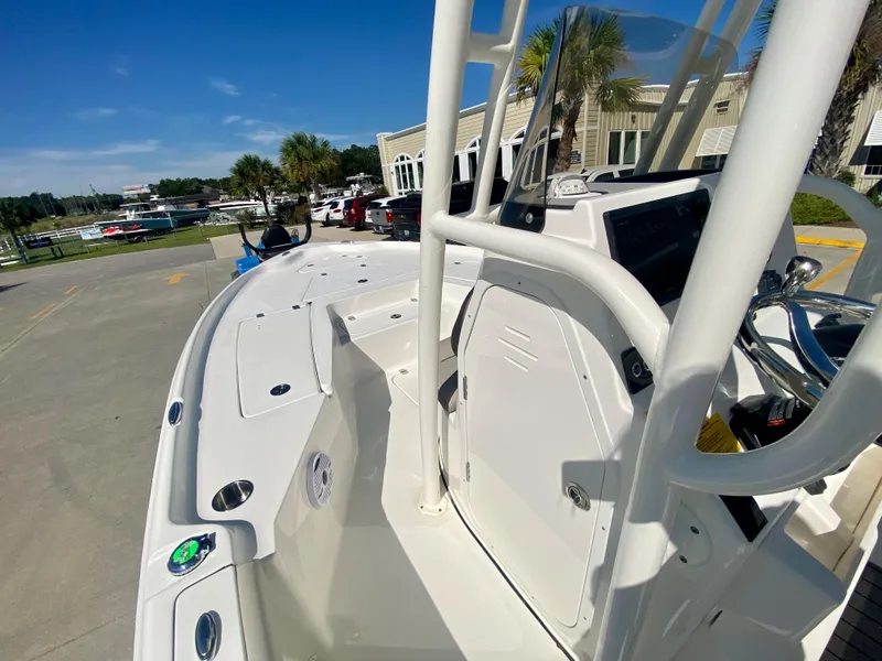 Slide: The Image of 2024 Key West 230 Bay Reef boat docked, showcasing its sleek design and spacious deck. - 17