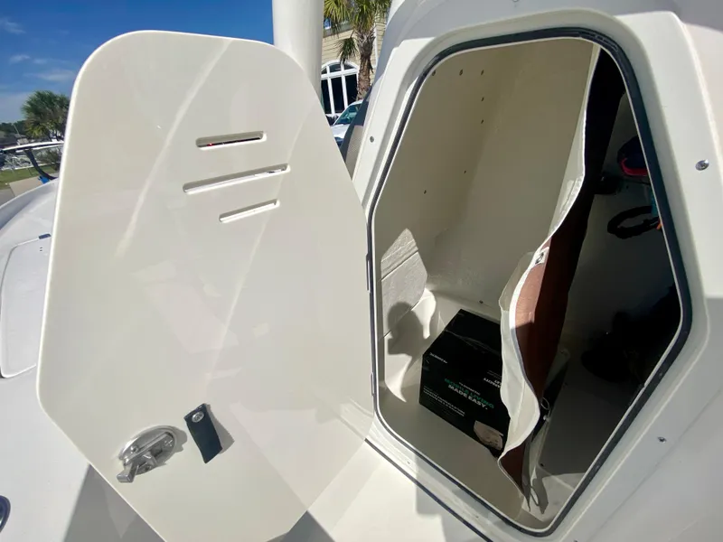 Slide: The Image of 2024 Key West 230 Bay Reef storage compartment with open door. - 18